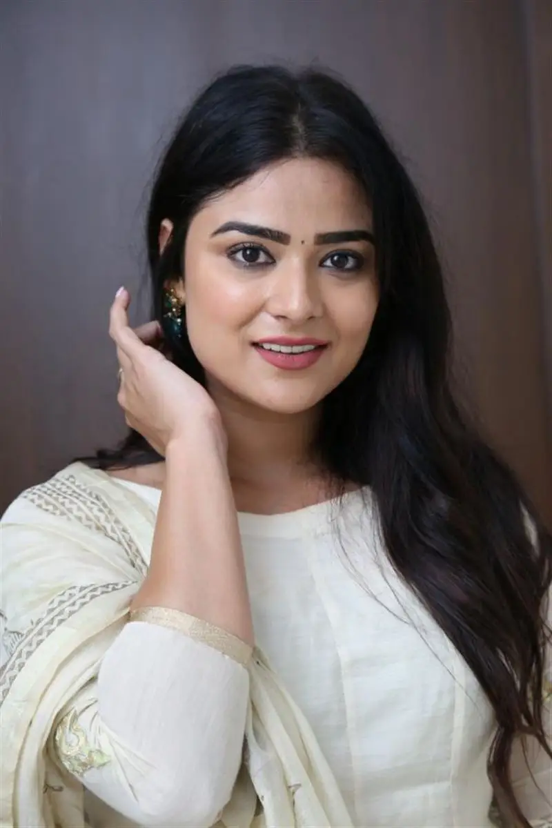 Telugu Actress Priyanka Sharma Smiling Stills in White Dress